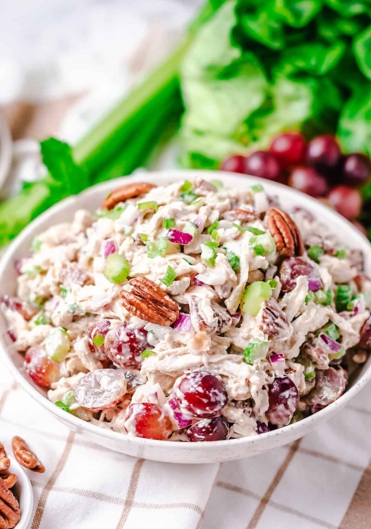 Creamy salad using leftover chicken meat with grapes and pecans in a large bowl.
