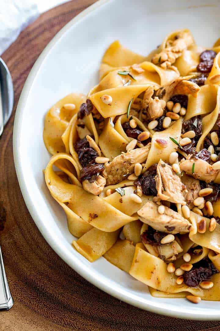 Pappardelle noodles with chicken and pine nuts.