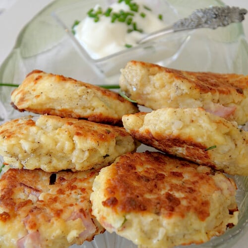 Golden mashed potato patties stacked with sour cream and chives.