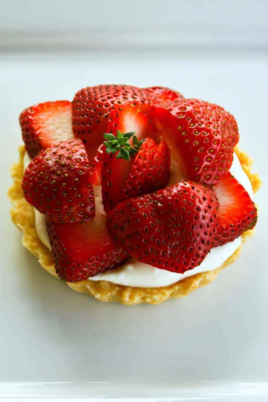 Fresh strawberries on a creamy, mascarpone bed in a tart shell.one