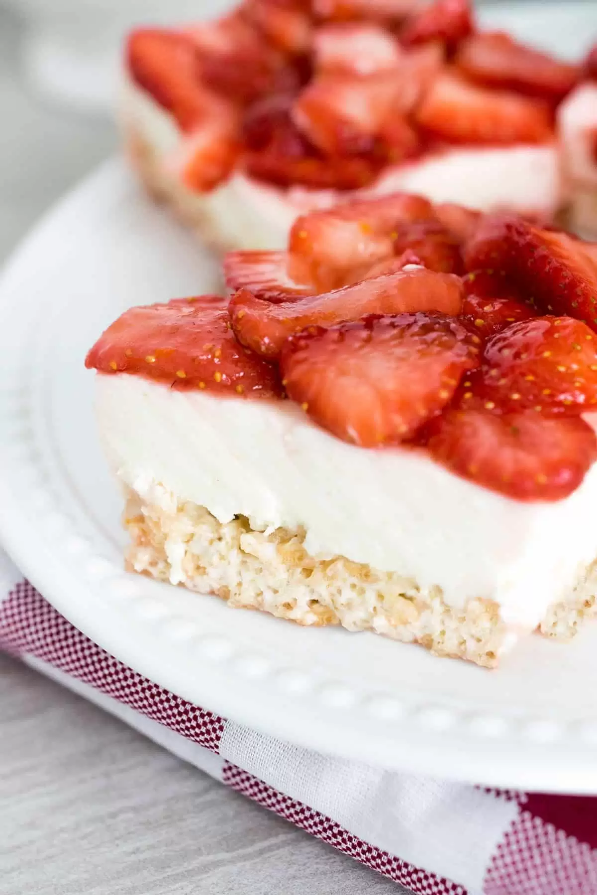No bake Rice Krispy crust with cream cheese layer topped with fresh strawberries.