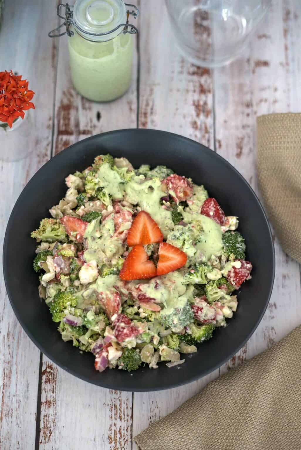 Overview of broccoli salad with strawberries and creamy dressing.