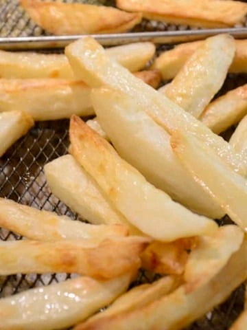 Salt and vinegar fries on a wire rack.