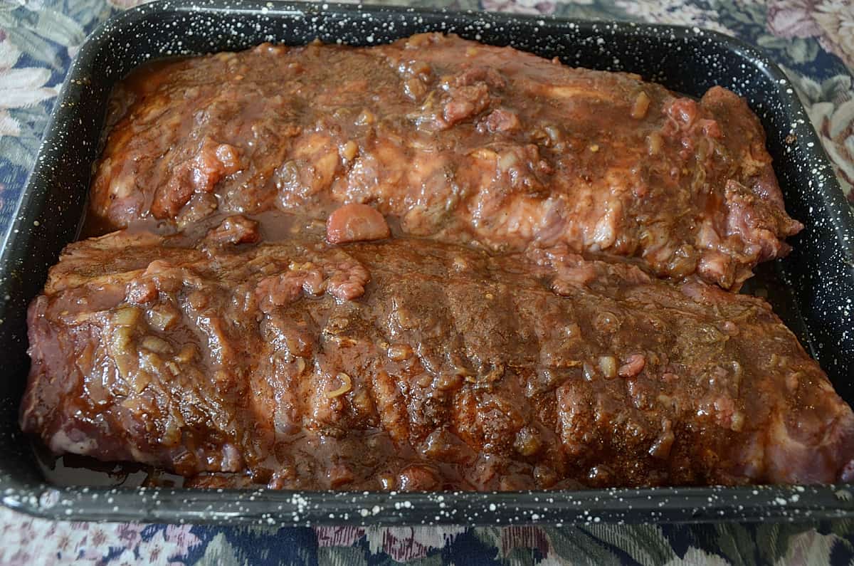 Pan of back ribs covered in Rhubarb bourbon BBQ sauce.