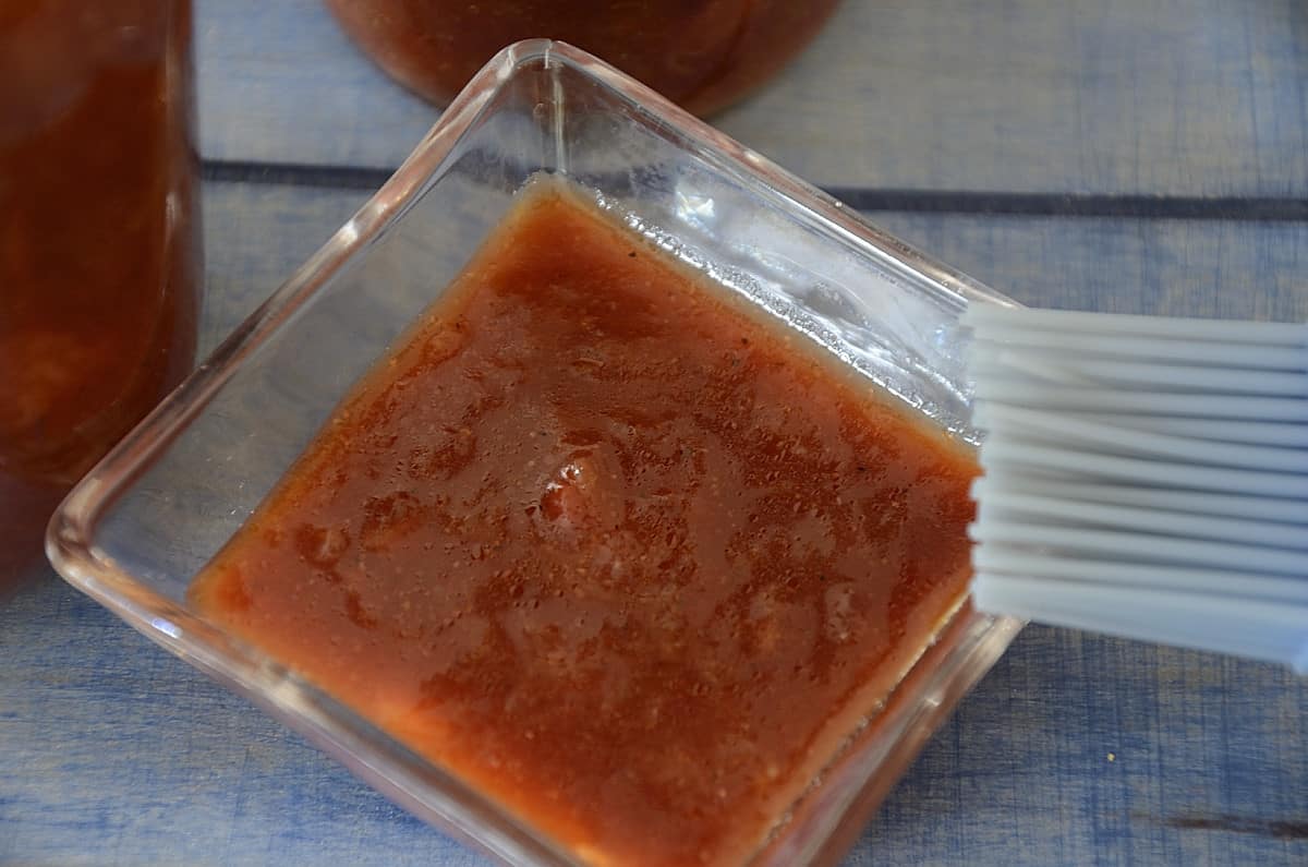 Rhubarb/strawberry sauce in a dish with a brush.