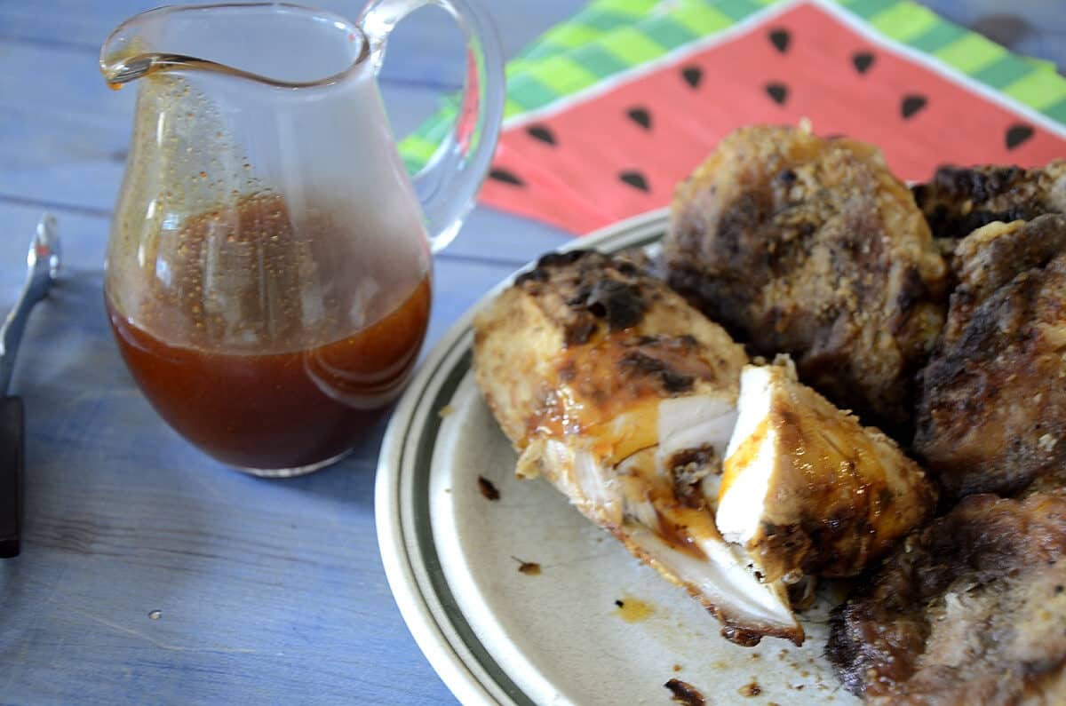 Air fried breaded pickle brined chicken on a plate drizzled with Hot Honey Sauce.