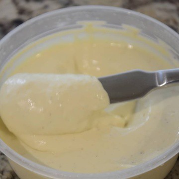 Silky, yellow corn mayonnaise in a tub.