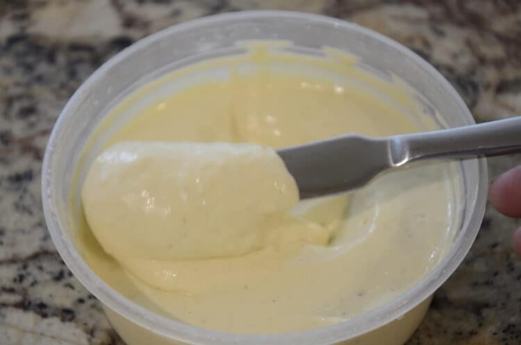 Silky, yellow corn mayonnaise in a tub.