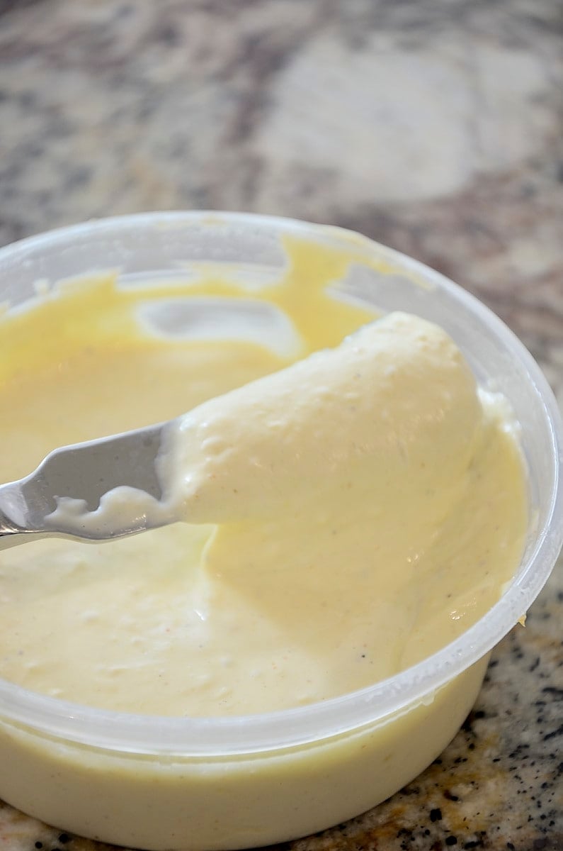 Silky, yellow corn mayonnaise in a tub.