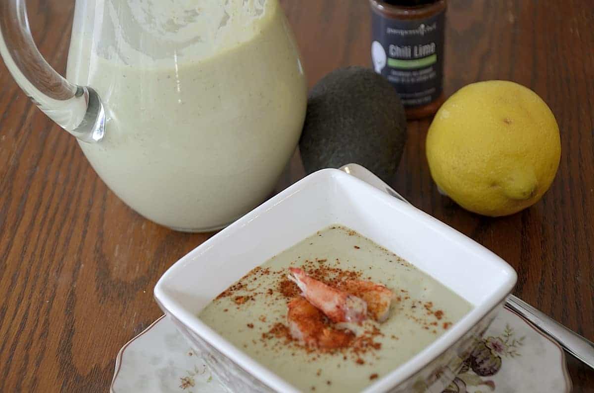 Chilled avocado soup with lobster and chili lime seasoning garnish.
