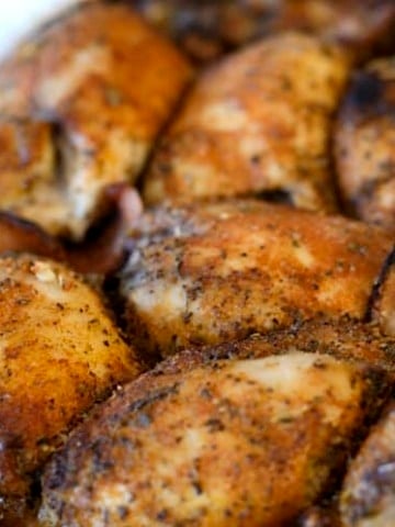 Close up of seasoned, crispy chicken thigh casserole.