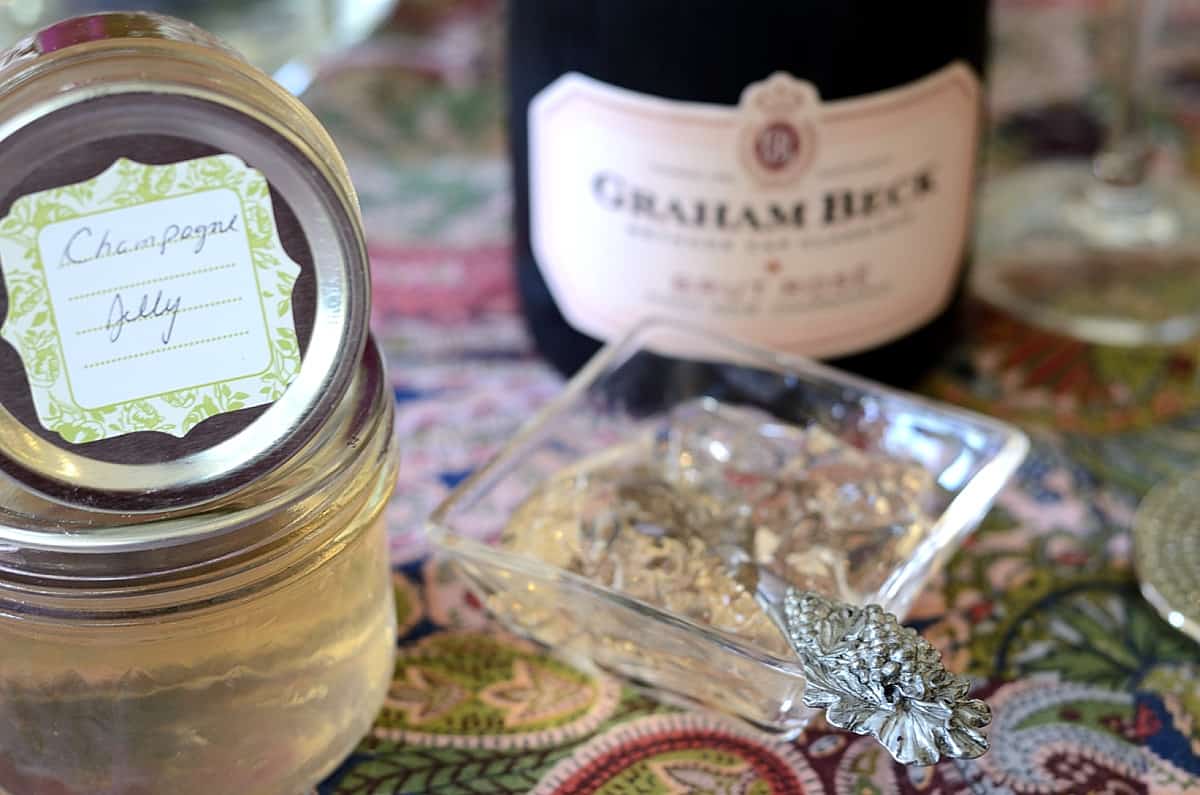 Glistening Champagne Jelly in a dish with jars of Champagne Jelly beside.