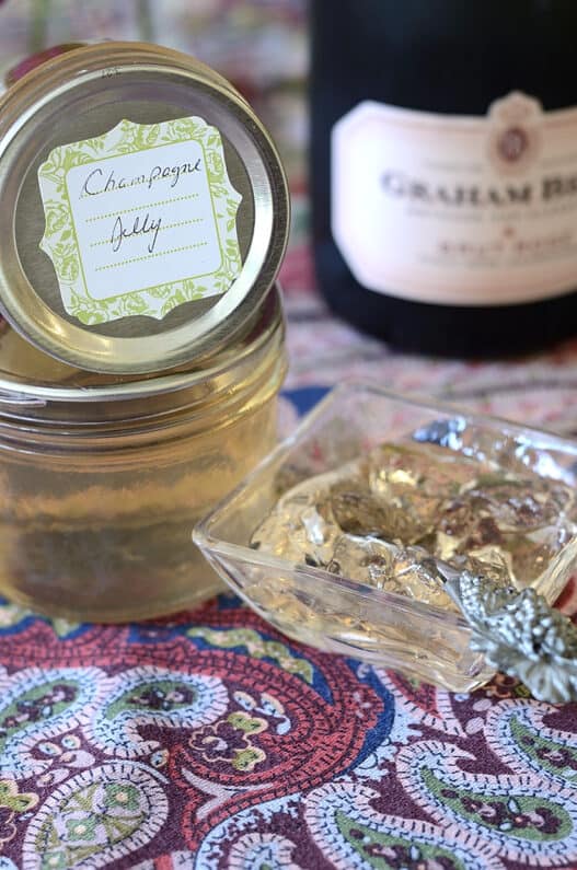 Glistening Champagne Jelly in a dish with jars of Champagne Jelly beside.