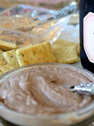 Close up of a dish of Champagne Pate with Champagne Crackers beside.
