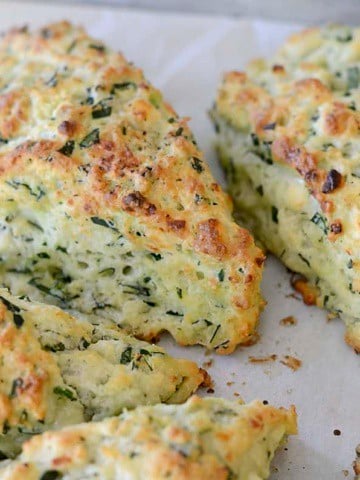 Golden brown spinach feta scones on a plate.