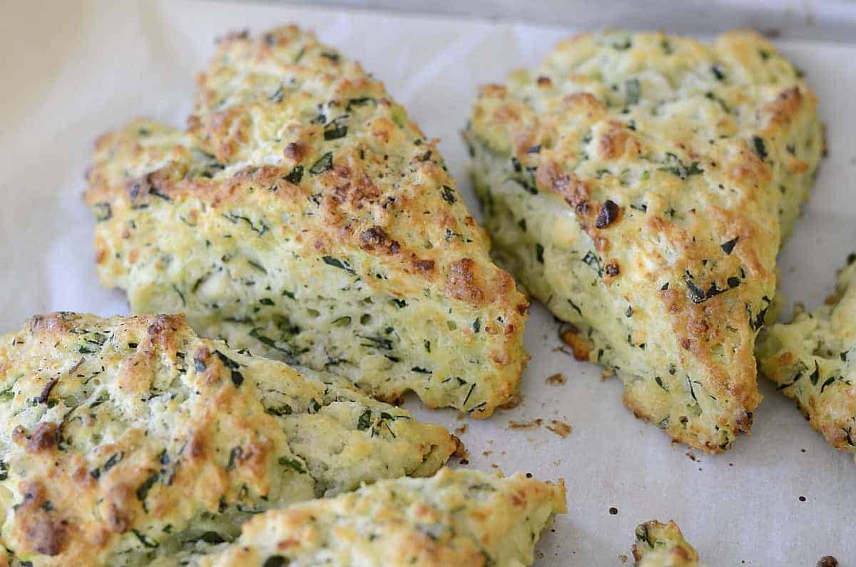 Golden brown spinach feta scones on a plate.