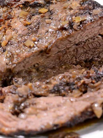 Brisket sliced on a platter with braised carrots.