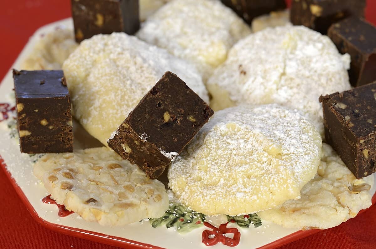 Toasted Almond Thins, Chocolate Cranberry Fudge and White Chocolate Chip cookies on a plate.