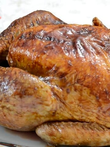 Close up of golden brown turkey, cooked from frozen, on a serving platter.