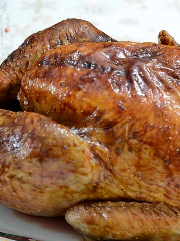 Close up of golden brown turkey, cooked from frozen, on a serving platter.