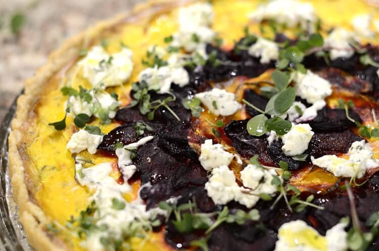 Butternut squash tart garnished with boursin cheese and microgreens.