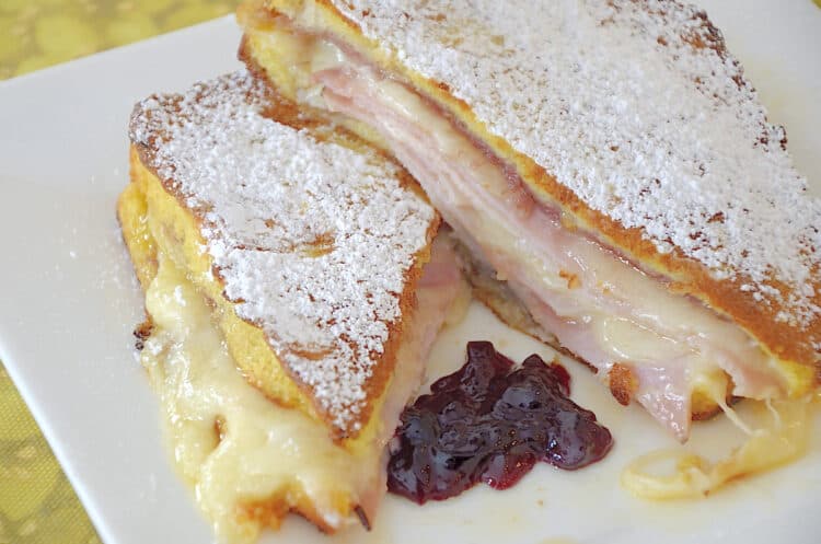 Monte Cristo sandwich with layers of deli ham, turkey and melted cheese.