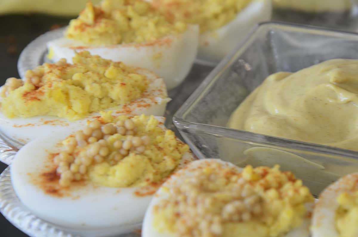 Deviled eggs with curry mustard mayonnaise and Mustard seed caviar for garnish.