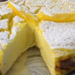 3 Ingredient yogurt cake dusted with icing sugar and garnished with fresh mango.