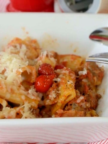 Pasta all Zozzona with rigatoni, sausage, pancetta and tomatoes garnished with fresh grated cheese.