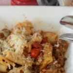 Pasta all Zozzona with rigatoni, sausage, pancetta and tomatoes garnished with fresh grated cheese.
