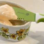 Close up of Sriracha mayo sauce in a small dish with a spreader.