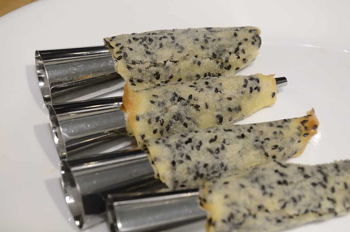 Four Sesame appetizer cones wrapped around the conical molds.
