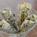 Four Sesame appetizer cones supported in a martini glass.