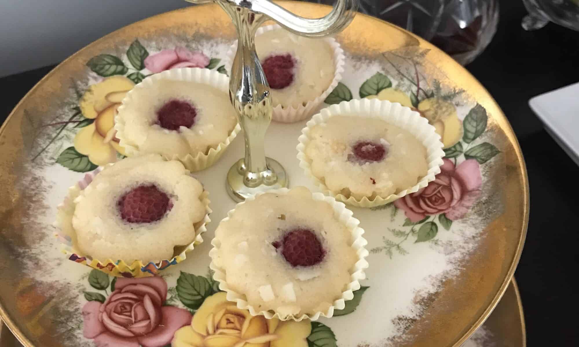 Raspberry Friands on a tiered tea plate.
