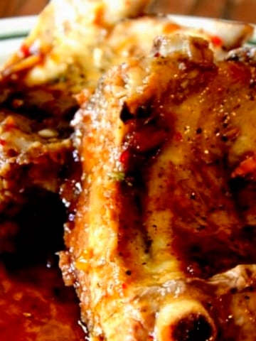 Close up of glossy ribs with mahogany soy glaze.