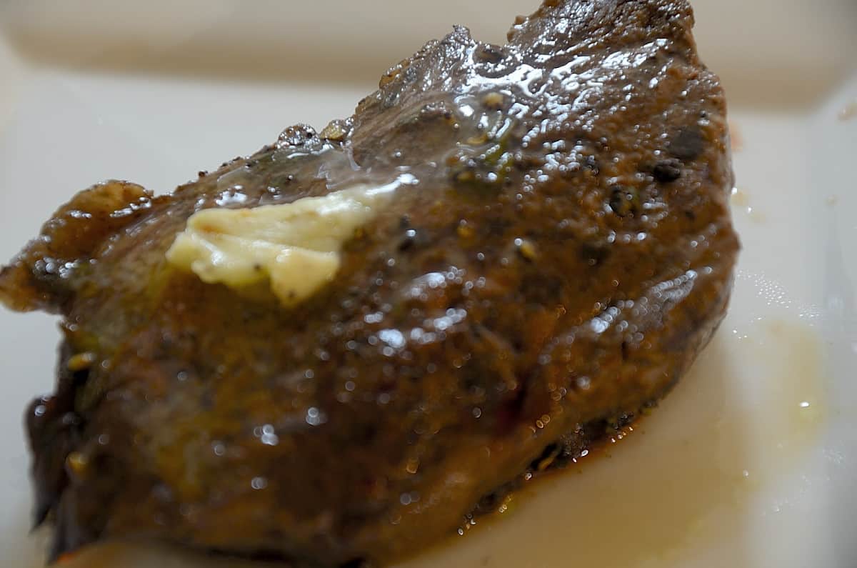 Grilled sirloin steak on a plate.