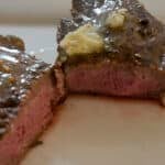 Grilled sirloin steak topped with herb butter.