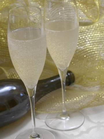 Two Champagne glasses of French 75 cocktail.