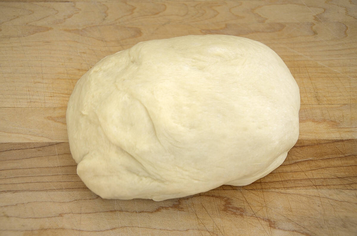 Dough for sweetened condensed milk buns formed in to log shape.